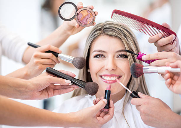 Woman getting a makeup makeover Beautiful woman getting a makeup makeover at the salon - beauty concepts lipstick photos stock pictures, royalty-free photos & images