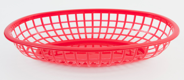 Empty red plastic food basket for home or restaurant. White background. Horizontal.