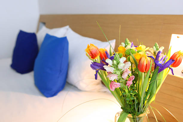 istock Flowers and a Bed with Pillows in the Hotel Room 470735048