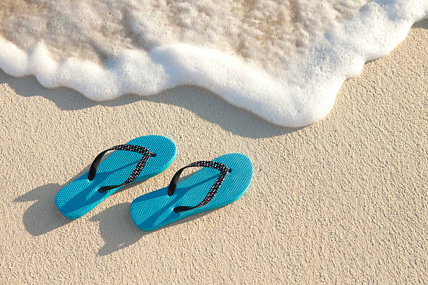 istock Turquoise Sandals On The Beach Near Water's Edge 470736344