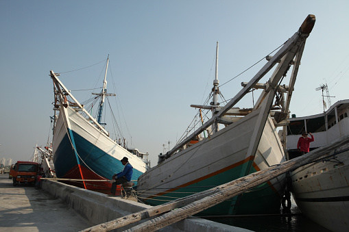Jakarta, Indonesia - August 16, 2011: Wooden sailing ships called pinisi in the historical port of Sunda Kelapa in Jakarta, Central Java, Indonesia.