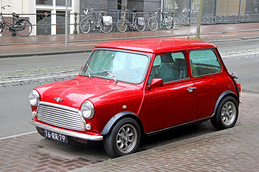 Amsterdam, Netherlands - August 10, 2014: Red retro car Austin Mini Cooper parked at the city street.