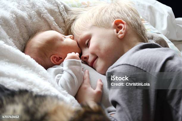 Big Brother Looking At Newborn Baby With Love Stock Photo - Download Image Now - Baby - Human Age, Sibling, Brother