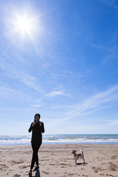 istock Girl at sea with dog 470744428