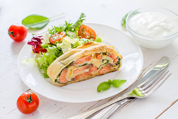 istock Strudel pie with salmon and spinach, served on white plate 470744484