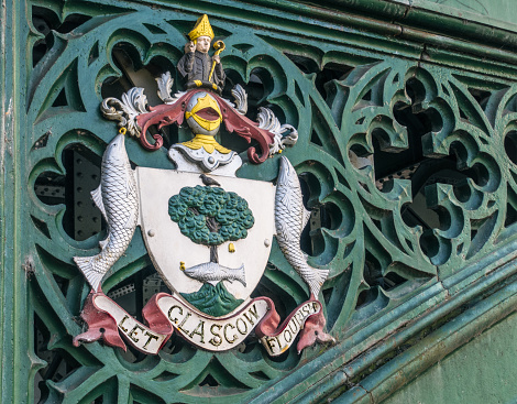 The traditional coat of arms for the City of Glasgow, Scotland, on a bridge in the city's West End.