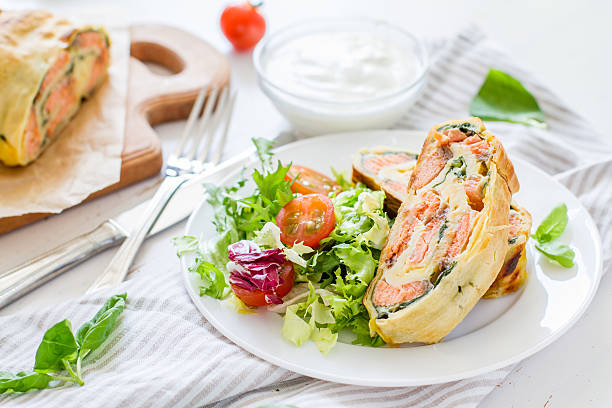 istock Strudel pie with salmon and spinach, served on white plate 470744612