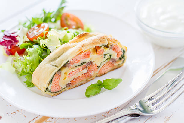 istock Strudel pie with salmon and spinach, served on white plate 470745050