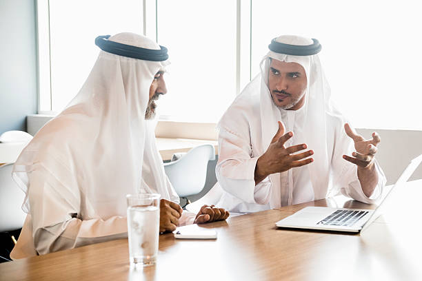 istock Middle Eastern Arab businessmen in traditional clothes discussing in office 470745406