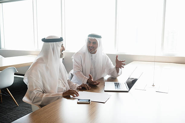 istock Businessmen in traditional clothes talking in office 470745422
