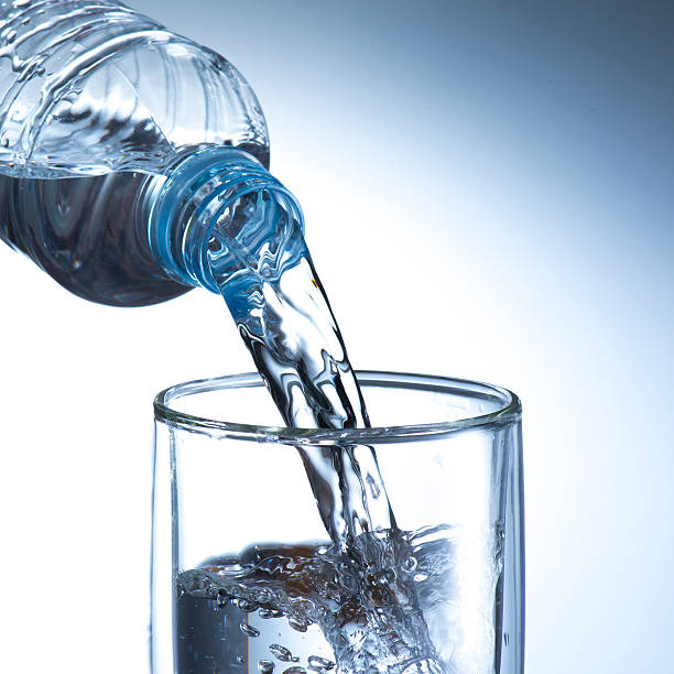 istock Hand holding bottle water and pouring 470746669