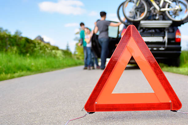 Car trouble hazard triangle on a highway stock photo