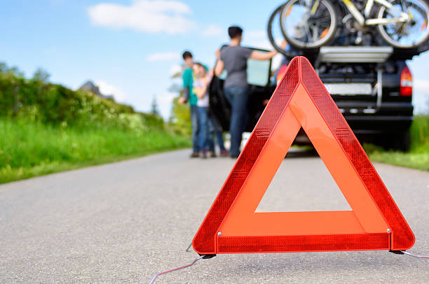 Car trouble hazard triangle on a highway Car Trouble - family is waiting for road assistance broken spring stock pictures, royalty-free photos & images