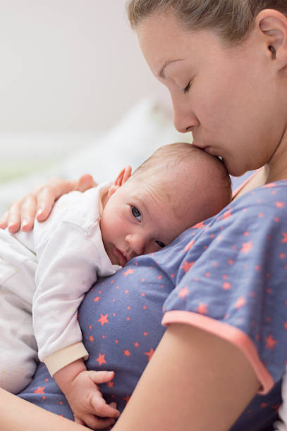istock Mother kissing her baby 470751278