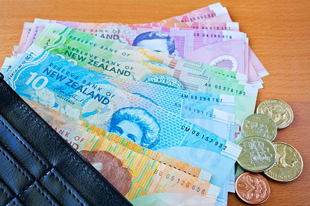 Wallet with New Zealand Money A wallet on a table, filled with New Zealand money. More New Zealand money -here new zealand dollar photos stock pictures, royalty-free photos & images