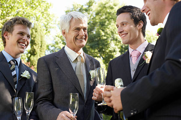 istock Men Holding Empty Champagne Flutes At Wedding 470753567