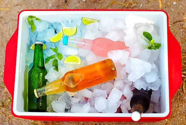 Photo of chilled colorful beverages in ice box. summer party