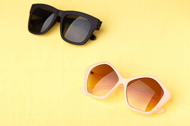 istock sunglasses on yellow wooden table 470755096