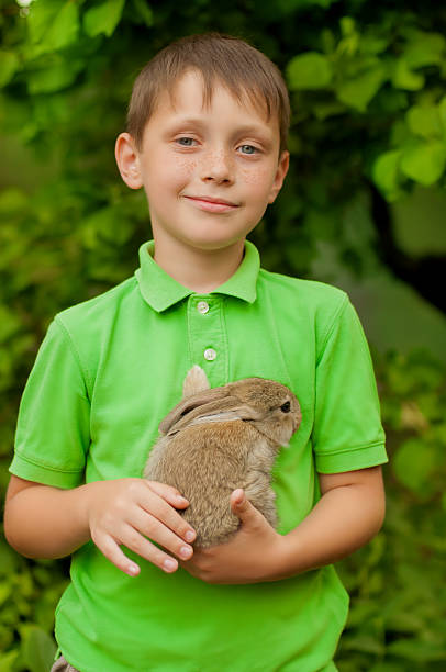 istock The little boy with a rabbit in the hands 470755904