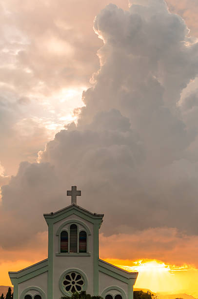 Classical church with sunset and orange clouds background