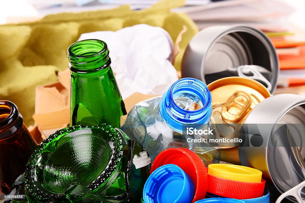 Recyclable garbage consisting of glass, plastic, metal and paper Recyclable garbage consisting of glass, plastic, metal and paper isolated on white background 2015 Stock Photo
