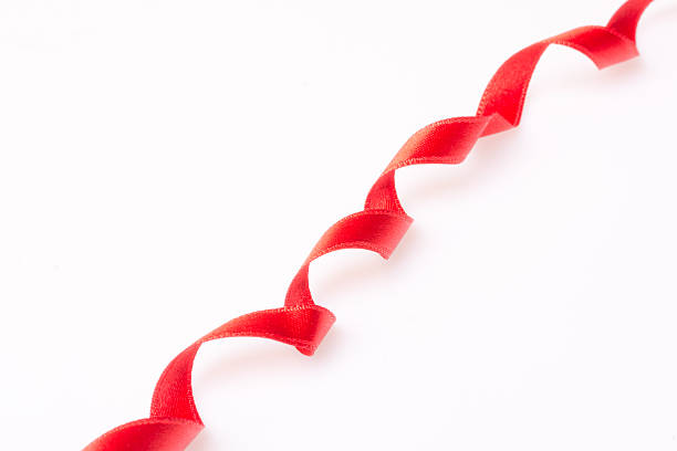 istock Red silk twisted ribbon in the form 470760380