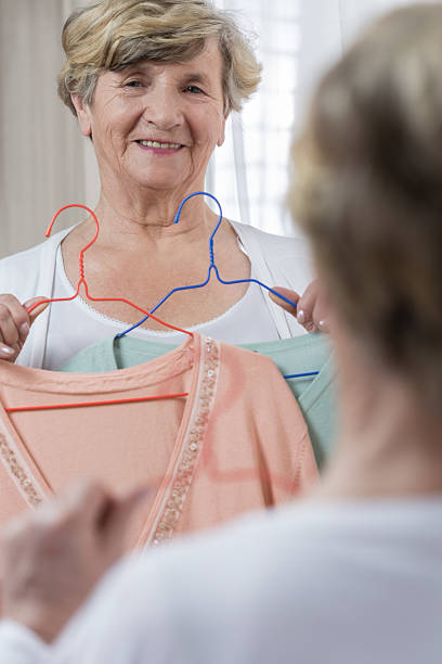 Senior woman choosing sweater
