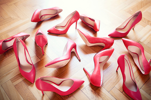 Large group of red high heels on the floor