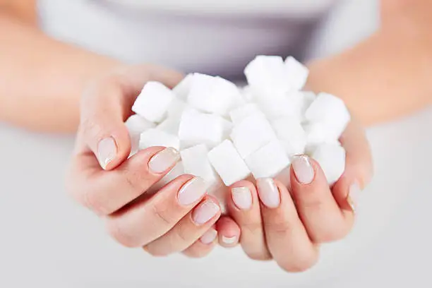 Photo of Woman holds in hands of sugar cubes