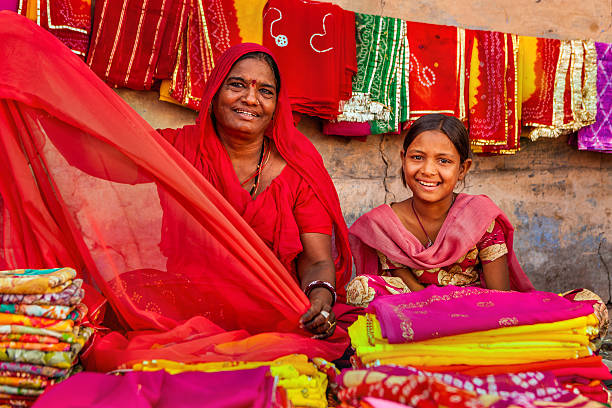 istock Indian women selling colorful fabrics 470765584