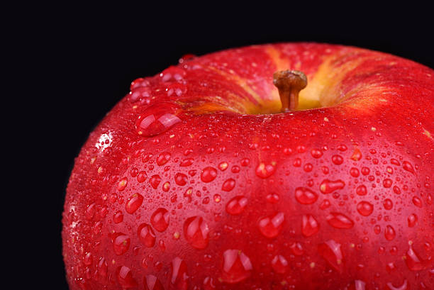 istock Red apple on dark background. Macro water drops 470766144