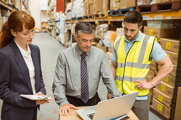istock Focused warehouse team working together on laptop 470766782
