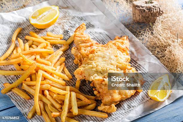 Tasty Fish Cod With Chips Served In Paper Stock Photo - Download Image Now - Fish, Newspaper, Potato Chip