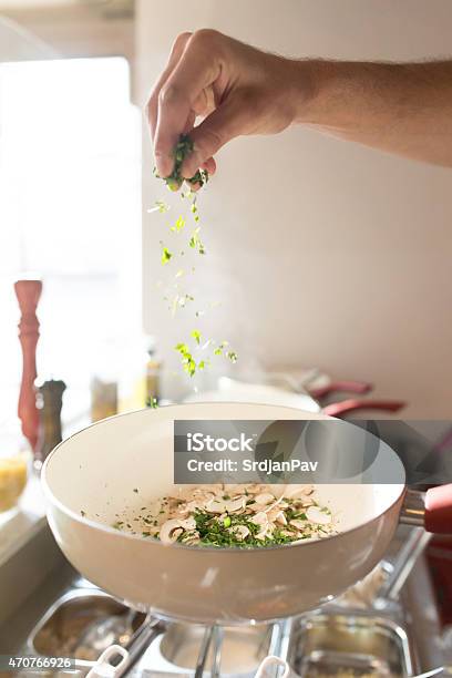 Spicing Mushrooms With Parsley And Basil Stock Photo - Download Image Now - Food, Spice, 2015