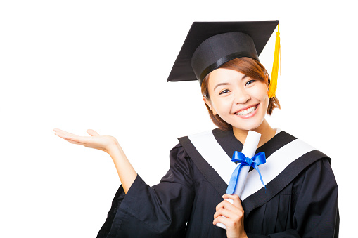 happy young woman graduating holding diploma and showing gesture