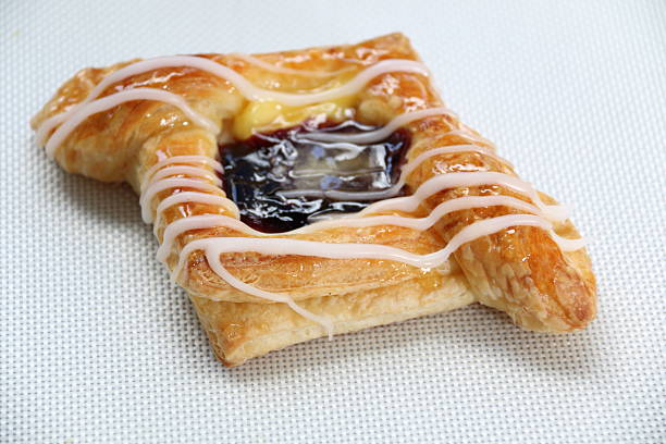 istock Danish pastry with blueberries jam on white. 470767994