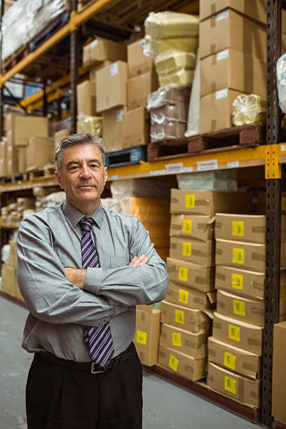 istock Smiling male manager with arms crossed 470769404