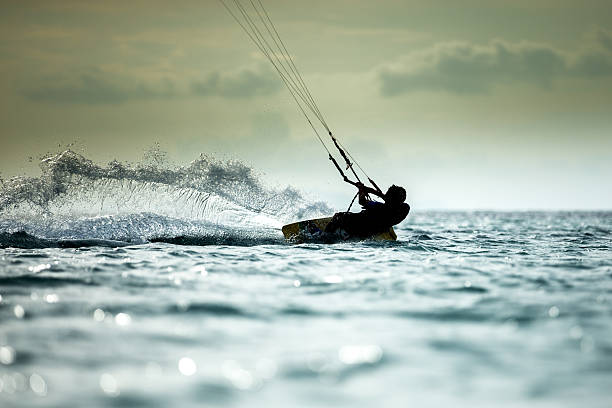 Kitesurfing kitesurfing rider doing trick in the air kiteboarding stock pictures, royalty-free photos & images
