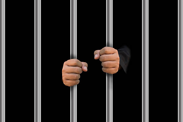 istock Man in jail hands close-up, depression and despair concept. 470770204