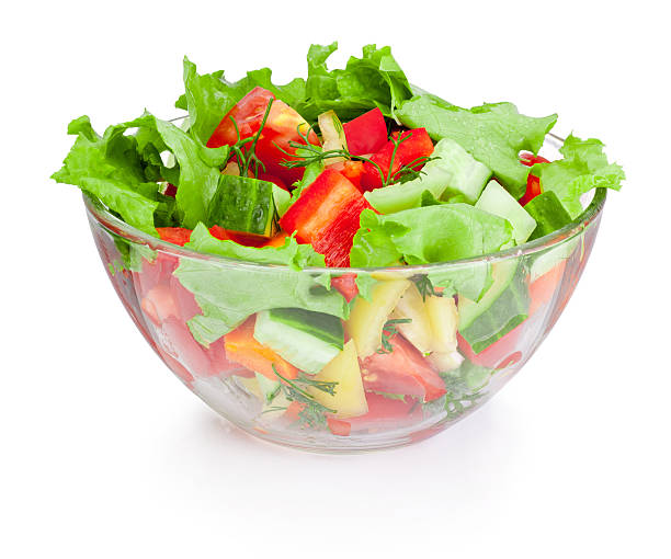 Fresh vegetable salad in glass bowl isolated on white background Fresh vegetable salad in glass bowl isolated on white background salad bowl photos stock pictures, royalty-free photos & images