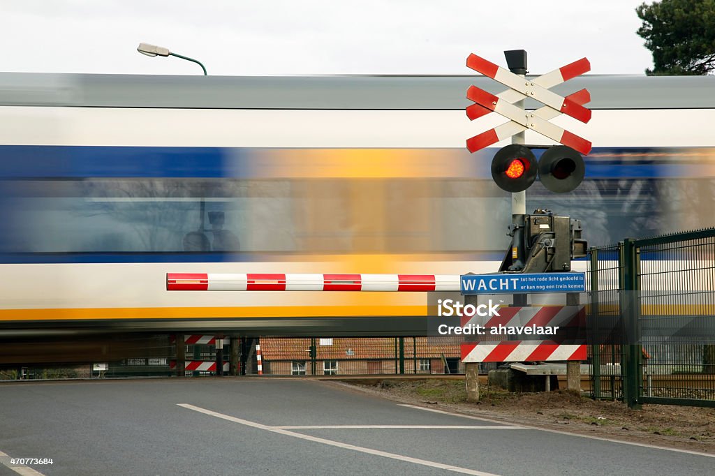 train speeding near railway crossing in holland train speeding near railway crossing in the netherlands Netherlands Stock Photo