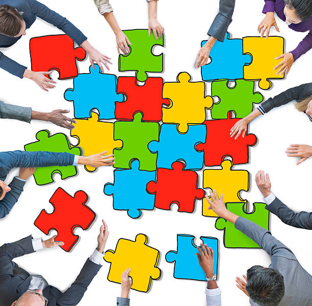 istock Group of People Forming Jigsaw Puzzles 470774600