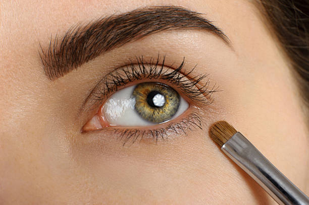istock A woman applying eye make up with a brush 470774808