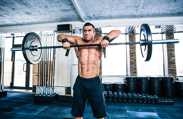 istock Handsome fitness man lifting barbell 470774850