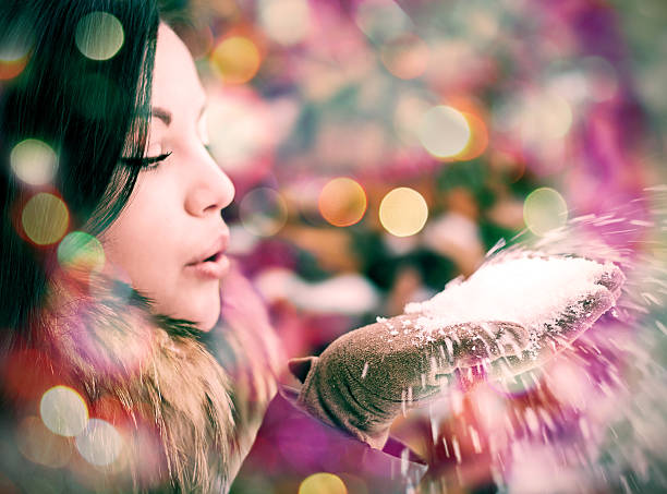 istock Girl blows snow from hands 470776007