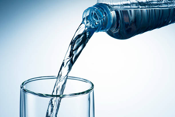 istock Hand holding bottle water and pouring 470776747