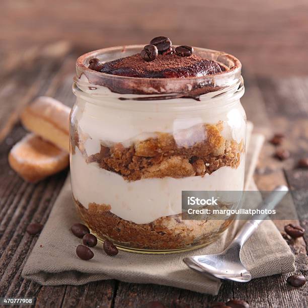 Creamy Delicious Tiramisu Served In A Mason Jar On A Table Stock Photo - Download Image Now