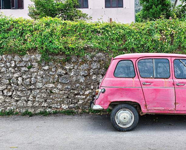 istock Pink car near an old brick wall 470778484