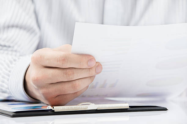 istock man hand with pen and business report 470778881