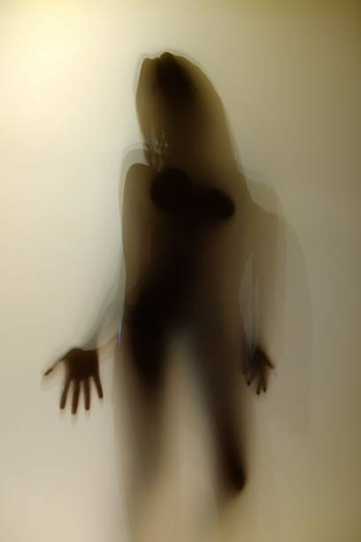 istock shadow girl behind the transparent door 470779036